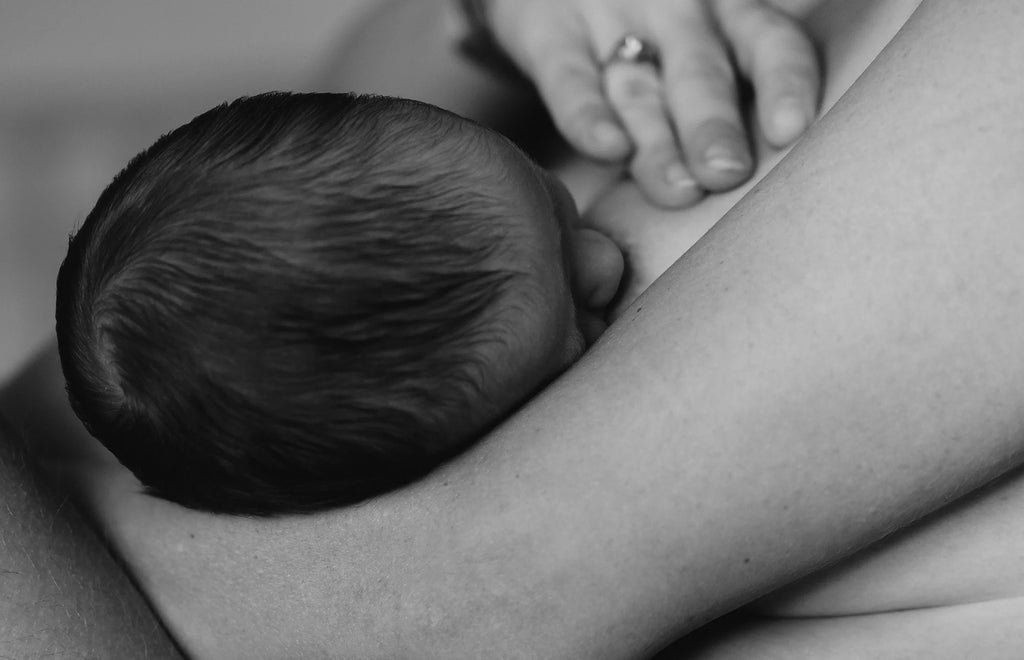 Breastfeeding Photo by @timothymeinberg at Unsplash