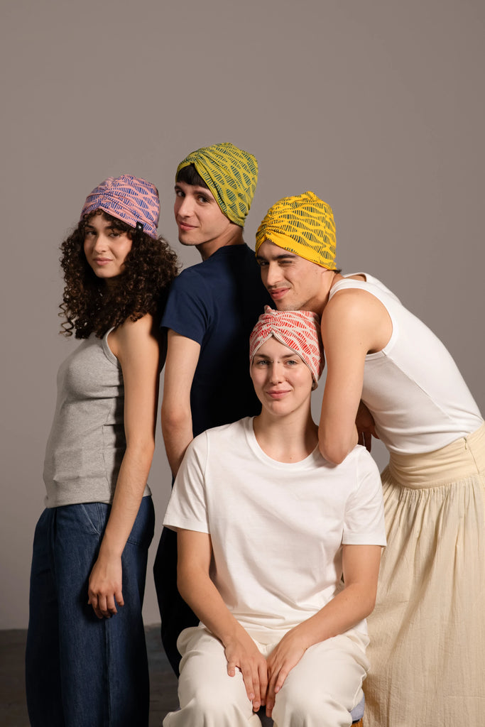 Cuatro jovenes posando con turbantes estampados de Happy Belly Barcelona